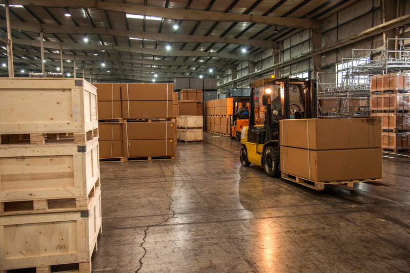 Forklift moving boxes in warehouse